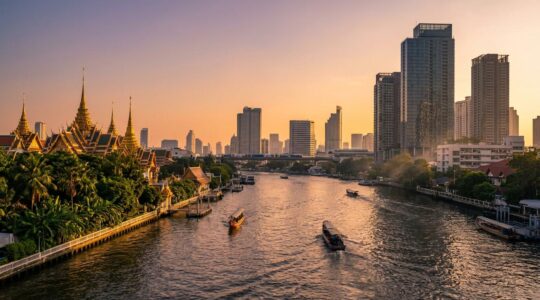 Vue panoramique de Bangkok mêlant temples traditionnels dorés et modernité urbaine avec le fleuve Chao Phraya